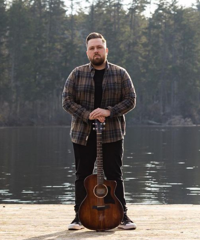 Kyle Ahern with acoustic guitar